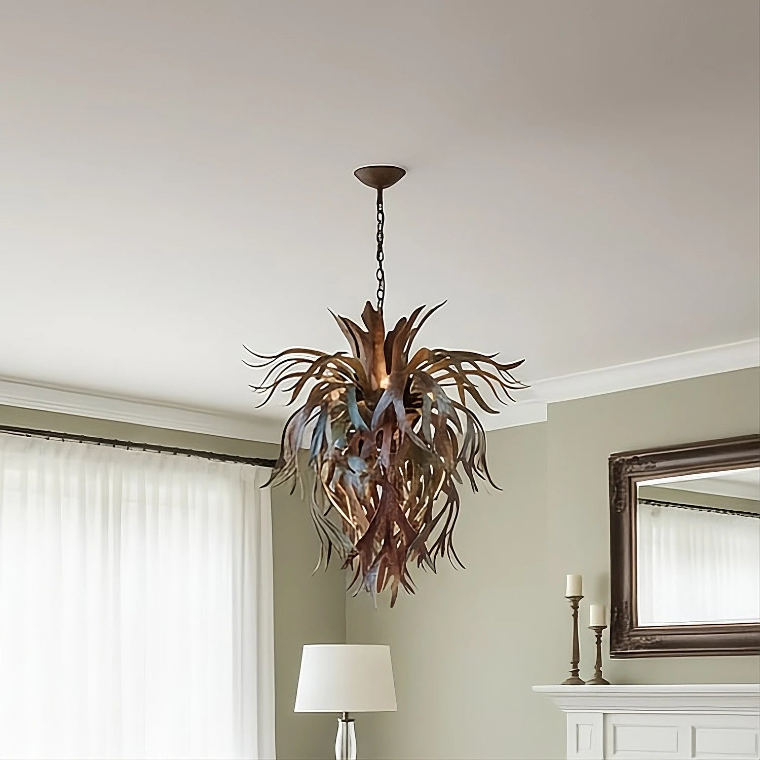 Platycerium. Our premier sculptural chandelier made of hand-forged metal shaped like staghorn fern fronds in our signature torched-copper finish, hanging from a matching chain against a neutral background