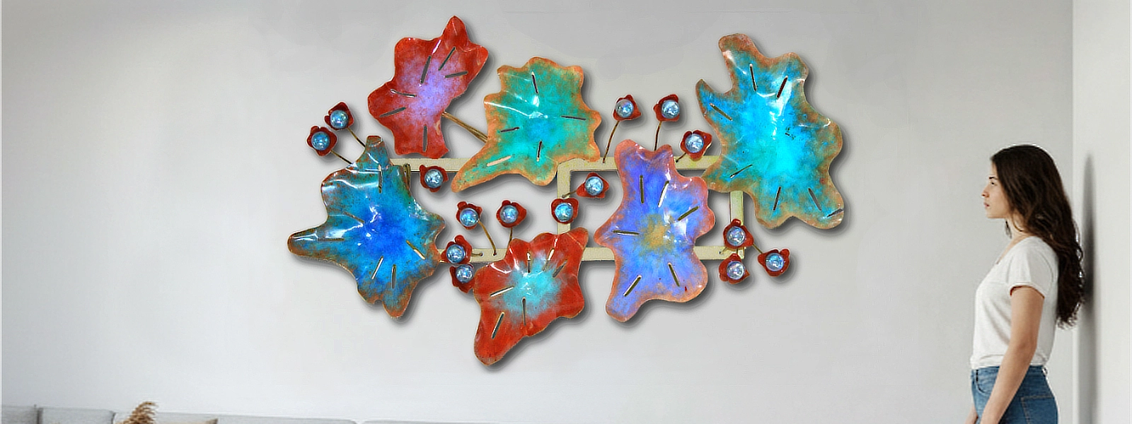 Woman looking at a wall art installation of colorful abstract shapes.