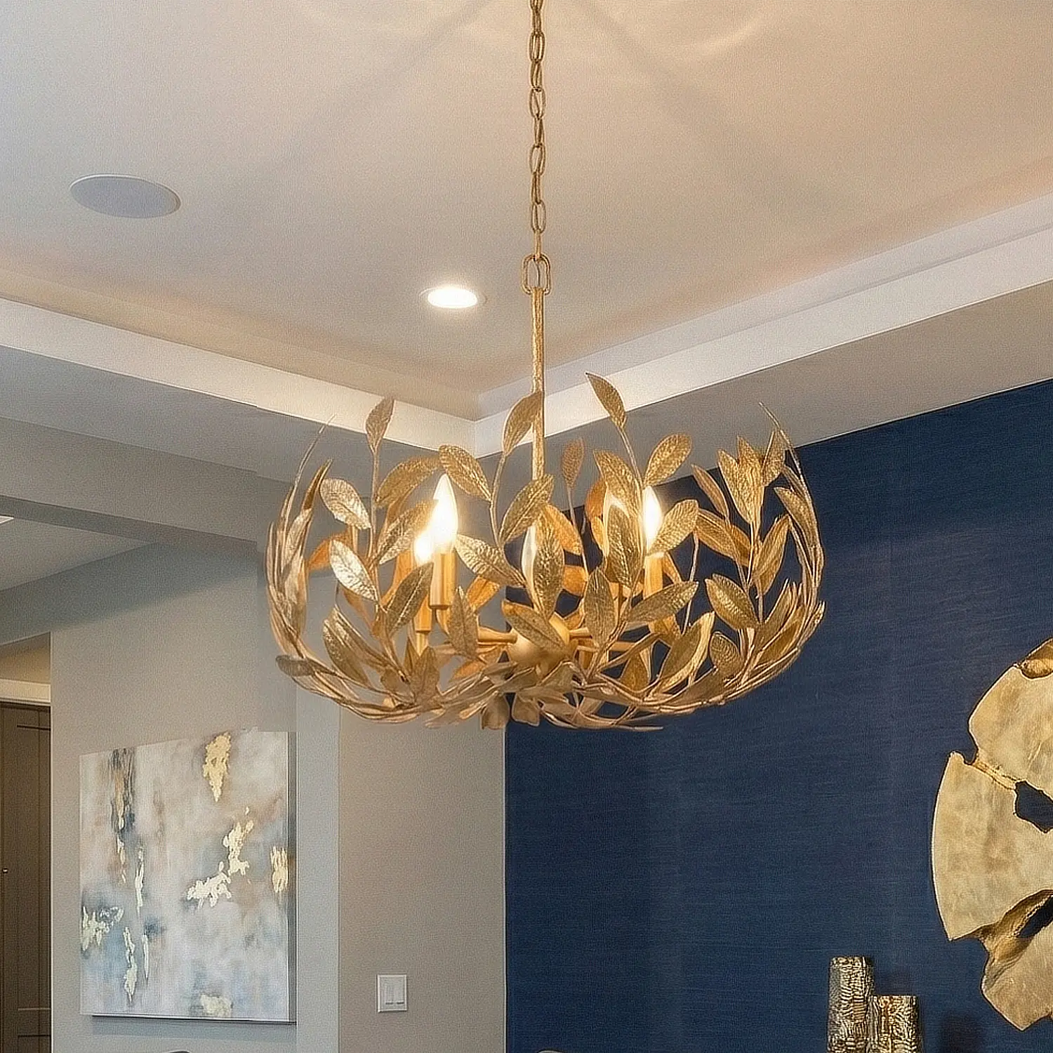 Volado Crown Chandelier in gold over an elegant dining table.