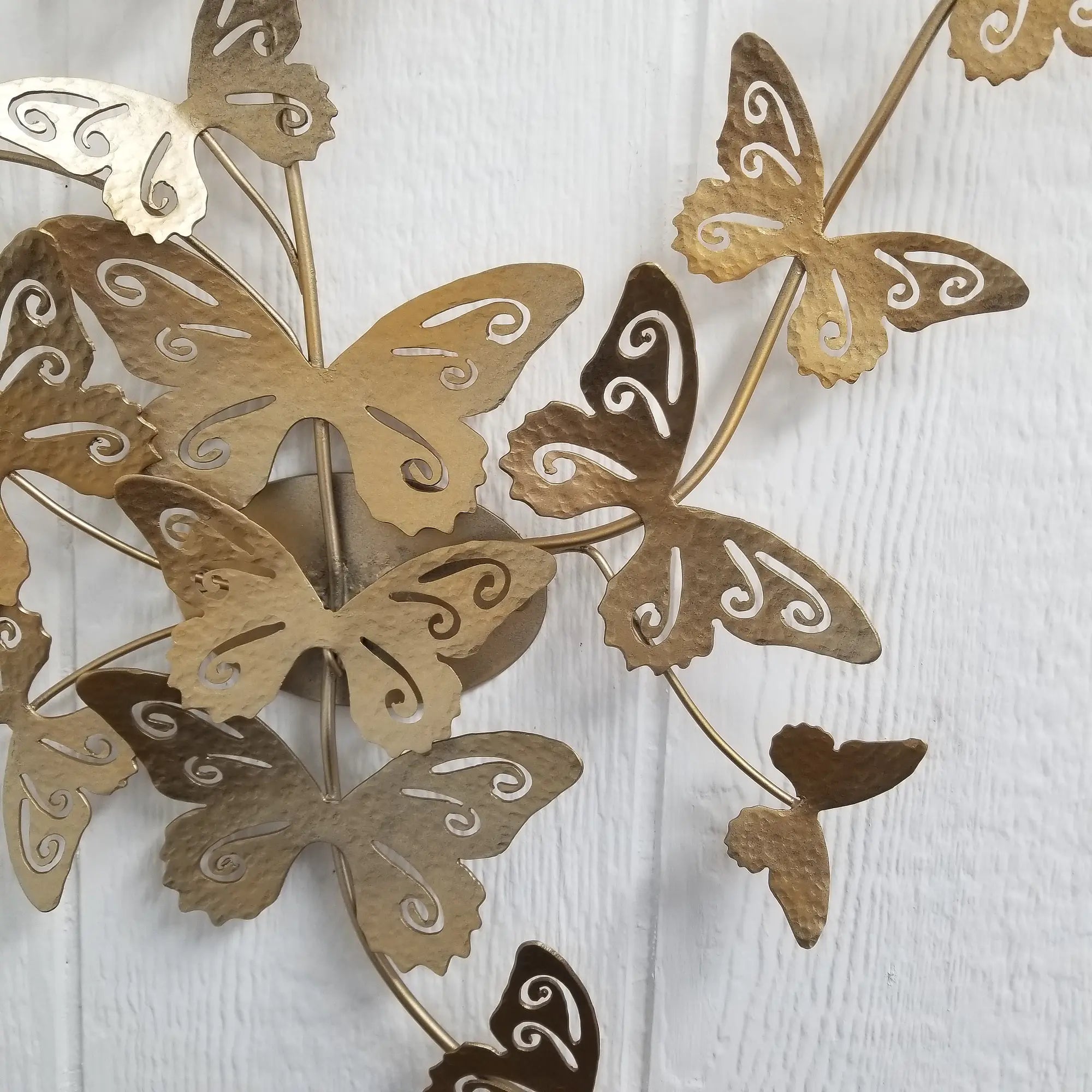 Close-up detail of a gold metallic butterfly wall art made of steel, sized 23x30 inches.