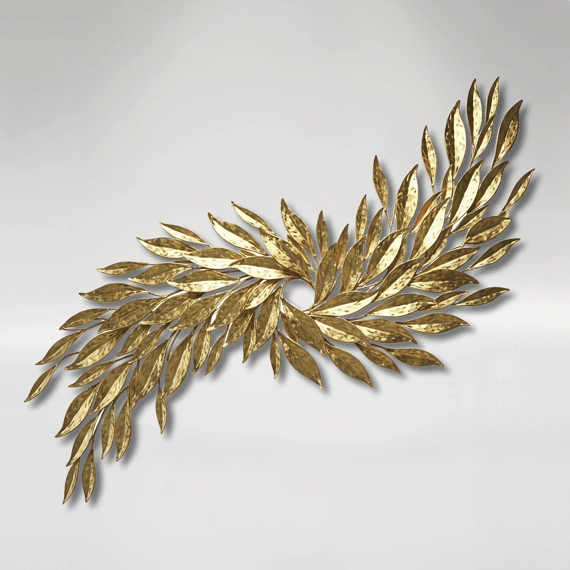 Gold tobacco leaf wall sculpture on a light gray background