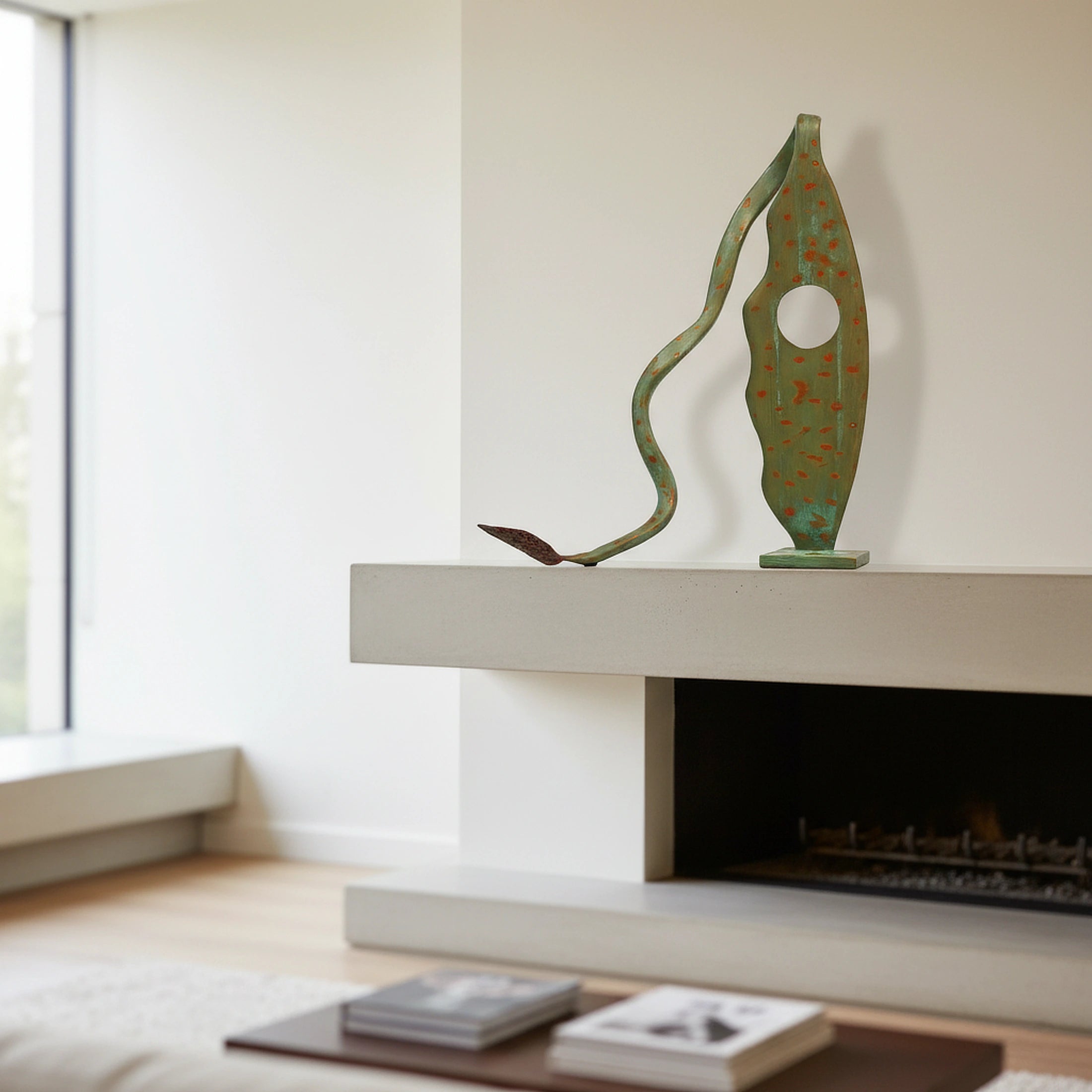 Abstract metal sculpture "Scoperta Terra" with green patina, serving as a statement piece on a fireplace mantel.