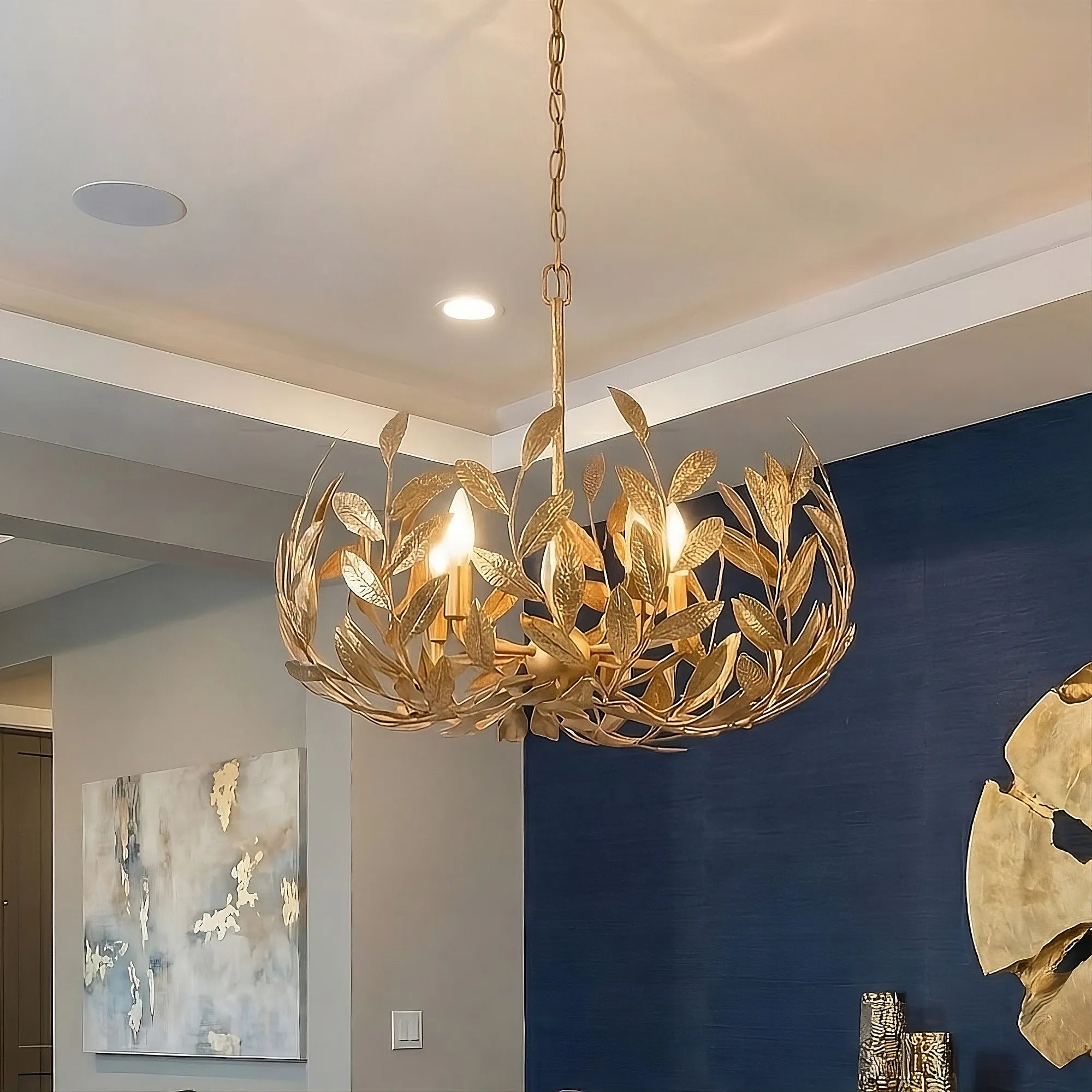 Volado Crown Chandelier in gold over an elegant dining table.