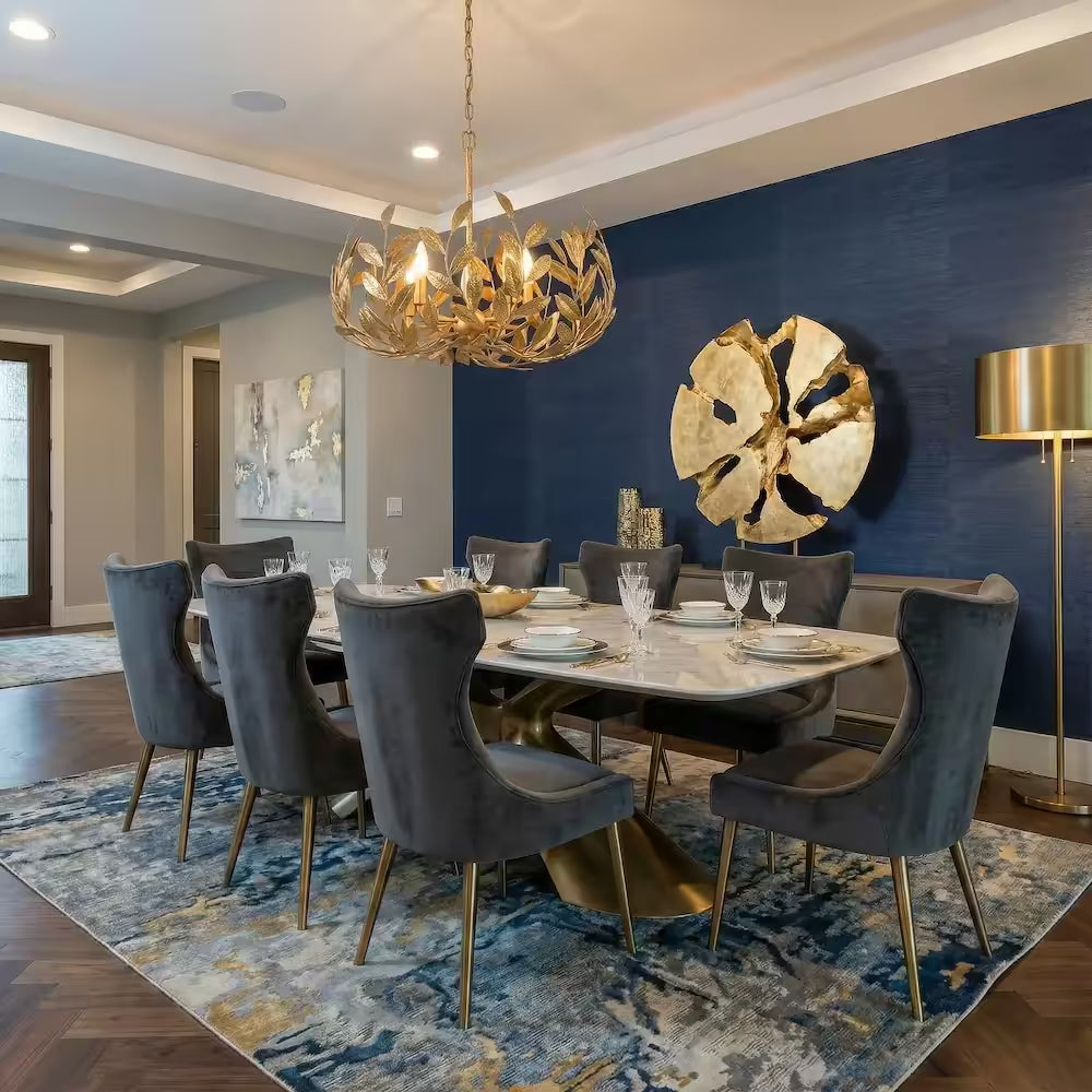 Modern hand-forged Volado Crown metal chandelier by Lago Luna hanging over a contemporary dining table, showcasing intricate artisan metalwork and warm ambient lighting.