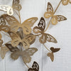 Close-up detail of a gold metallic butterfly wall art made of steel, sized 23x30 inches.