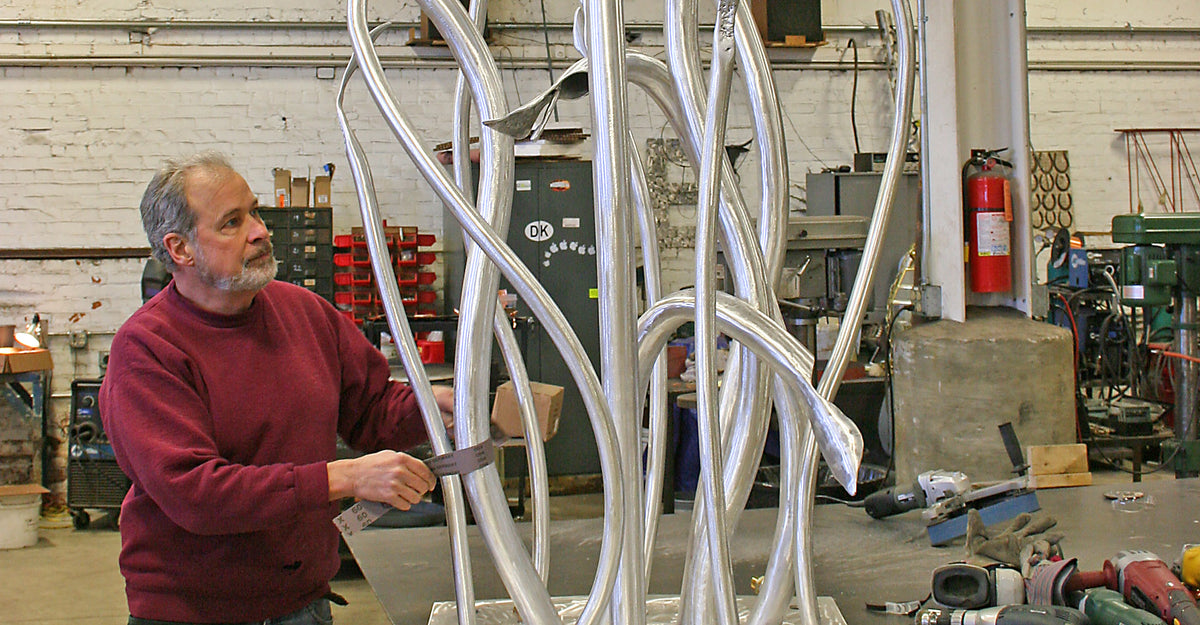Marc Staples working on an abstract sculpture in a former studio space. 